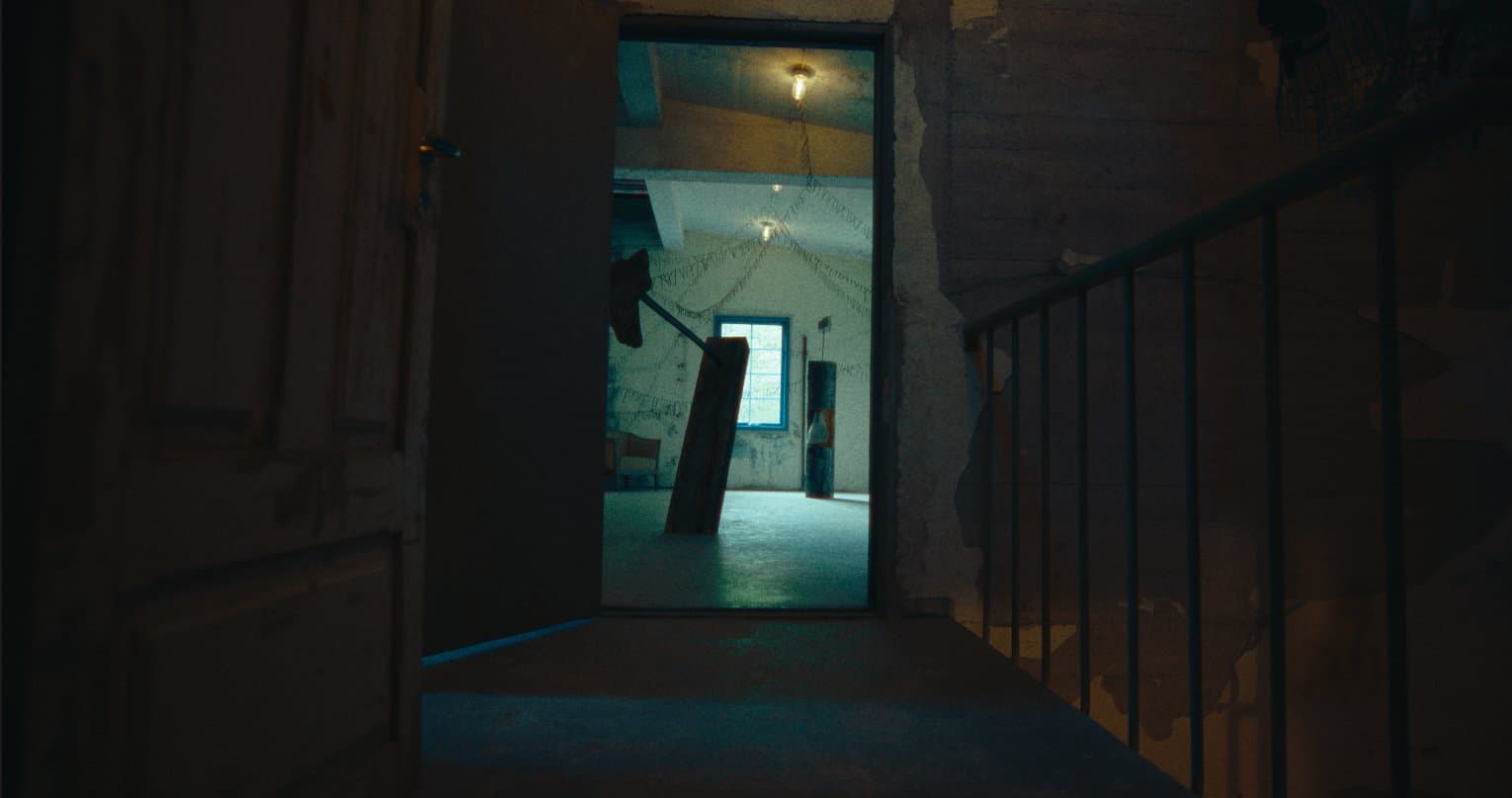 The sculpture seen through an open doorway from a stairwell landing
